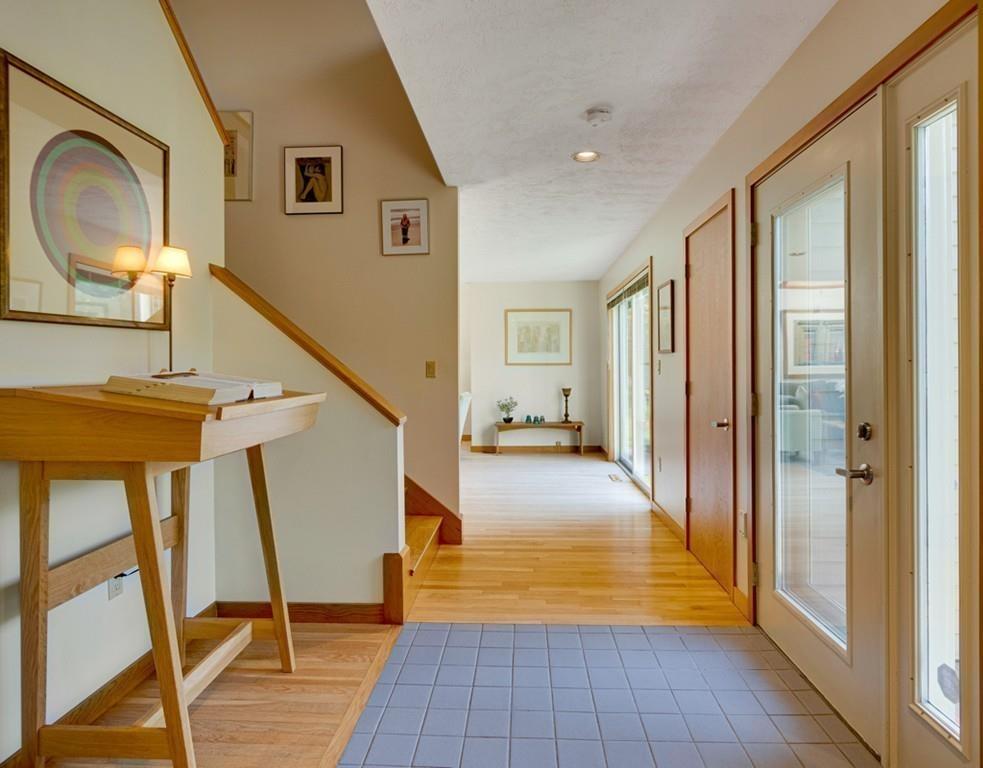 161 Tower Road Lincoln, MA 01773 - Photo 8 of 28 a view of a hallway with wooden floor and furniture