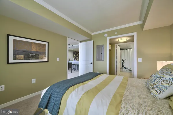 a bedroom with bed and wall painting