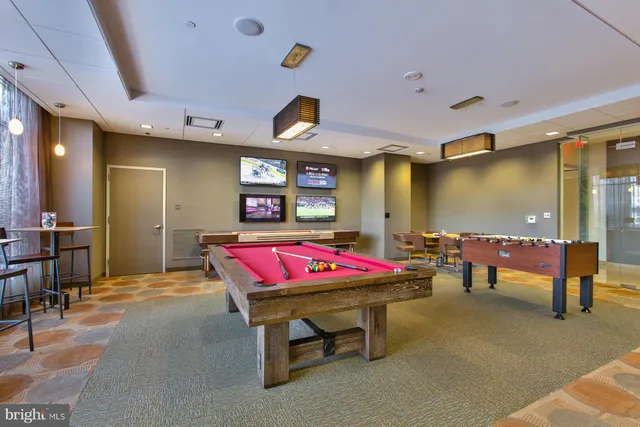 a room with furniture and pool table
