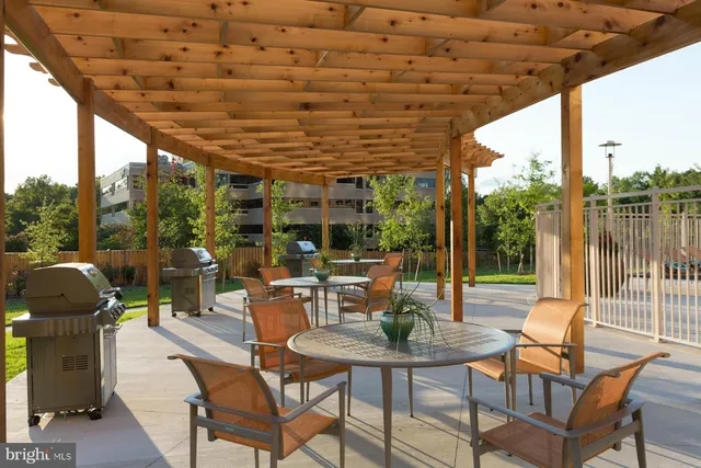 a view of a patio with a table chairs and a couple of flower plants