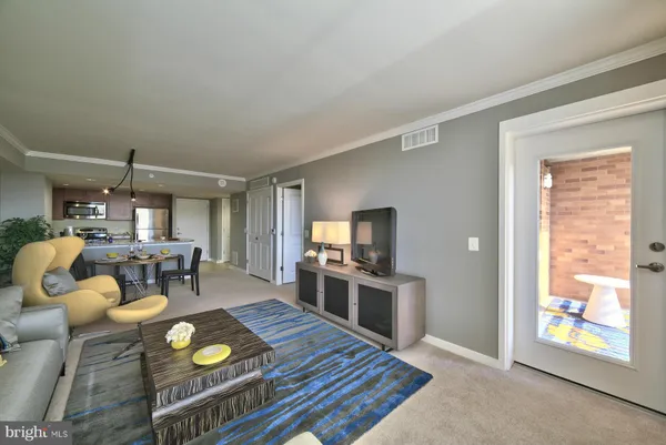 a kitchen with stainless steel appliances granite countertop a stove top oven a dining table and chairs with wooden floor