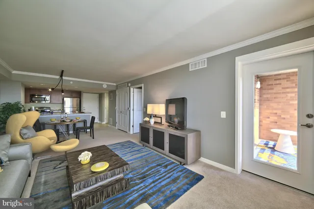 a kitchen with stainless steel appliances granite countertop a stove top oven a dining table and chairs with wooden floor