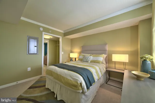 a bedroom with a bed and a lamp