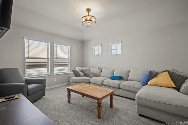 a room with gym equipment and a flat screen tv