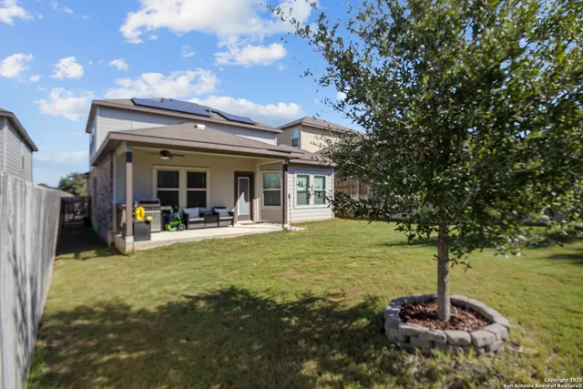 a view of house with yard and sitting area