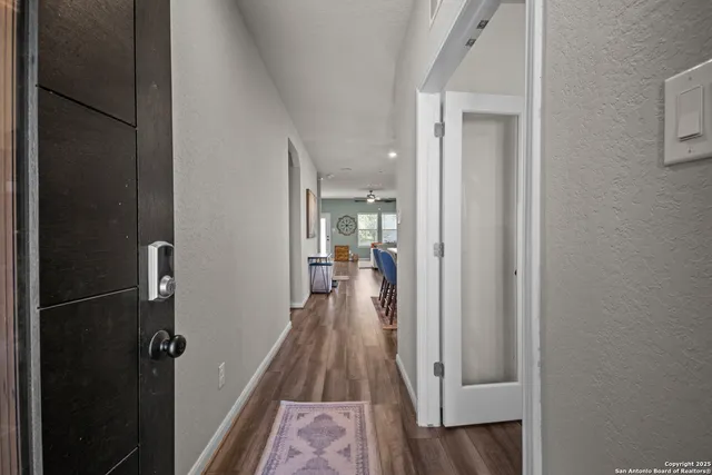 a kitchen with stainless steel appliances a refrigerator and wooden floor