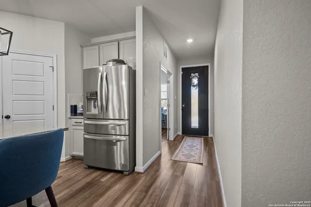 a dining room with furniture and wooden floor