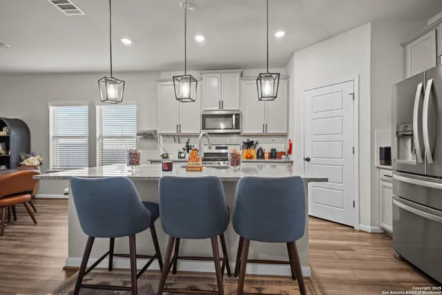 a kitchen with stainless steel appliances granite countertop a stove and a sink