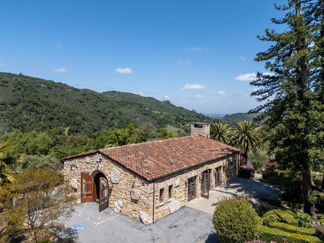 a roof deck with table and chairs under an umbrella