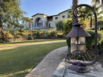 an empty room with windows and ceiling fan