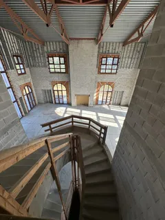 a view of a livingroom with wooden furniture and windows