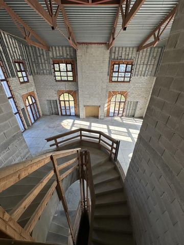 a view of a livingroom with wooden furniture and windows