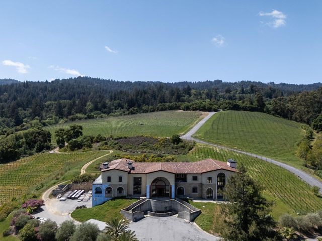 an aerial view of a house with garden space and outdoor seating