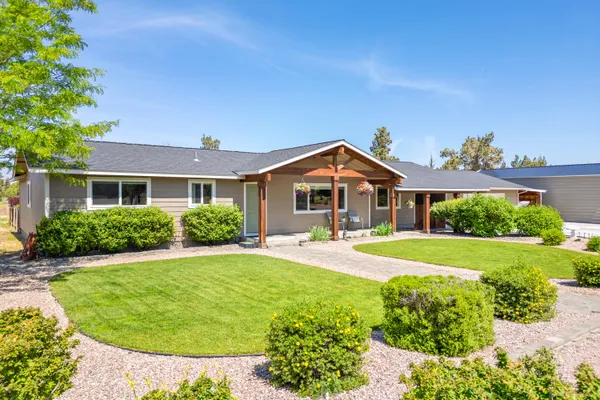 a front view of a house with yard and green space