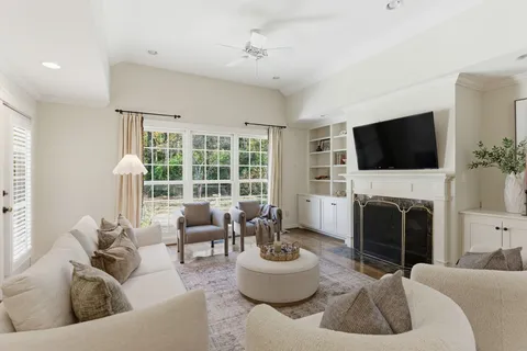 a living room with furniture a flat screen tv and a fireplace