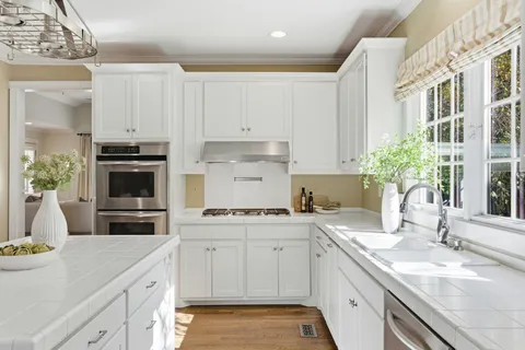 a kitchen with a sink stove and cabinets
