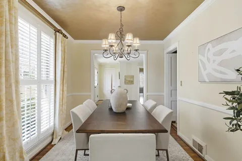 a dining room with furniture and window