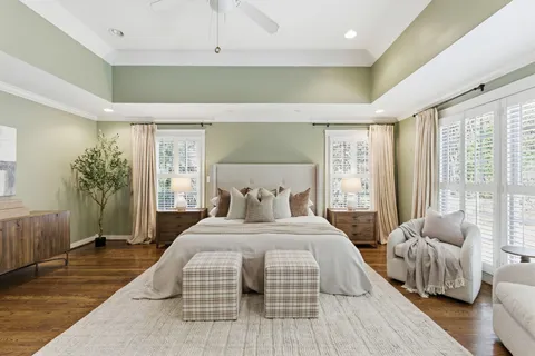 a bedroom with a bed and a large window