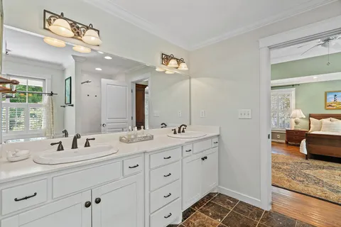 a en suite bathroom with double sink and a mirror