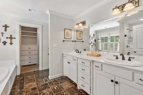 a bathroom with a double vanity sink mirror and
