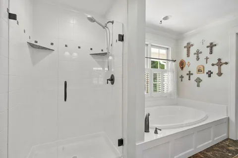 a white bath tub sitting next to a shower