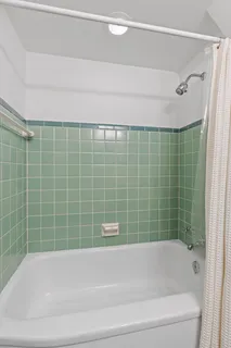 a bathroom with a bathtub and a shower