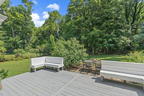 a wooden bench sitting in the middle of a yard