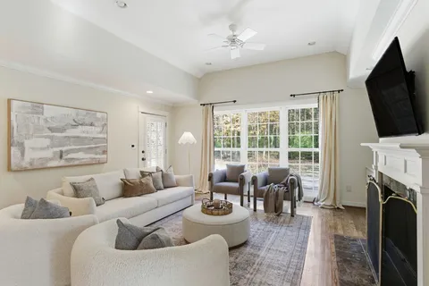 a living room with furniture a fireplace and a flat screen tv