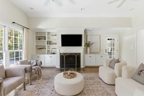 a living room with furniture a fireplace and a flat screen tv