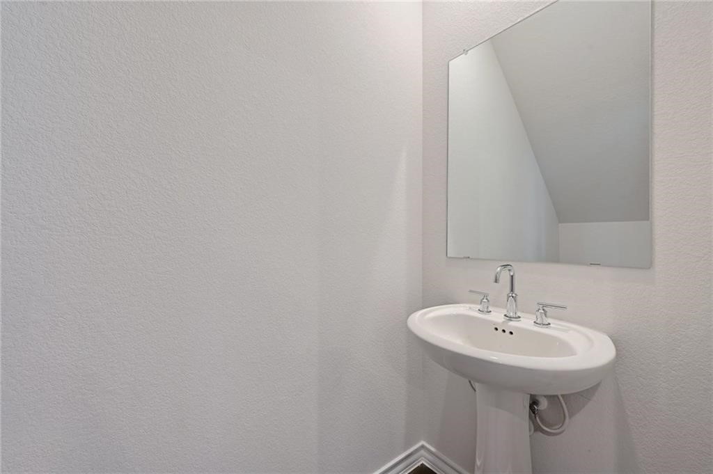 806 Pepperbark Loop Buda, TX 78610 - Photo 13 of 39 a bathroom with a sink and a mirror