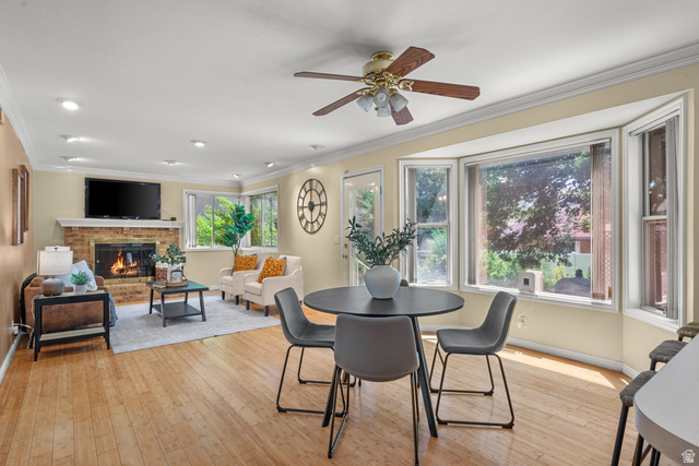 1726 Wasatch Boulevard Sandy, UT 84092 - Photo 7 of 38 Living area featuring wood-finish flooring, a brick fireplace with a white mantel, recessed lighting, and a ceiling fan