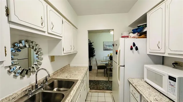 a kitchen with a sink and a stove top oven