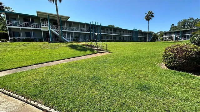 a view of a house with a backyard
