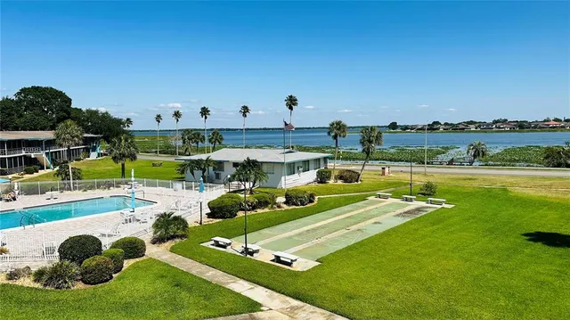 a view of a swimming pool and a yard