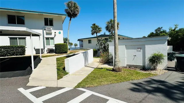 a view of backyard with swimming pool and seating space