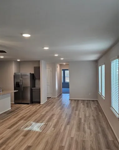 a view of a kitchen with a sink and a refrigerator