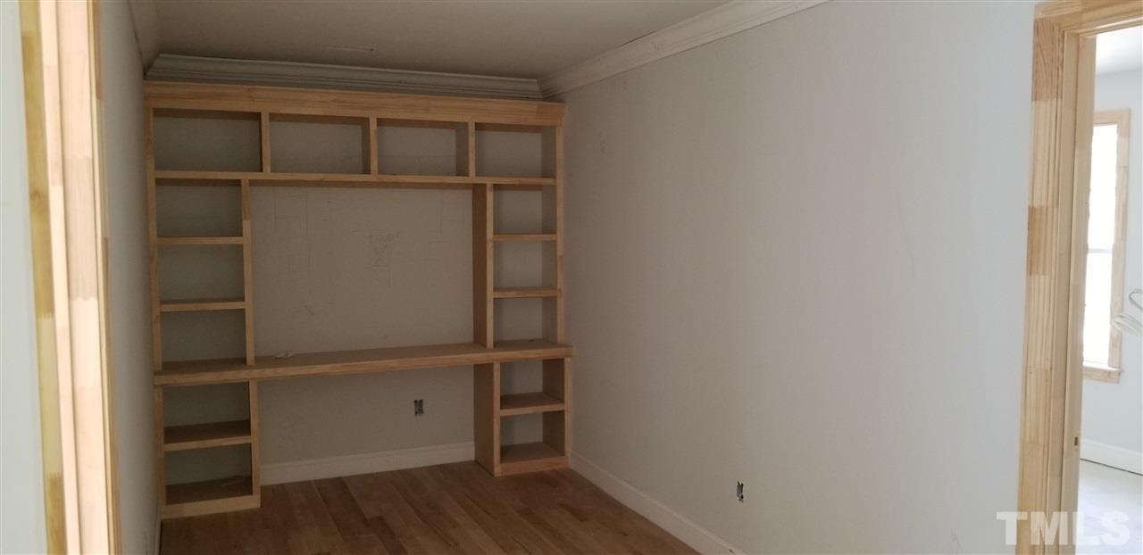 447 Rose Lane Raleigh, NC 27610 - Photo 4 of 8 a view of walk in closet with empty racks