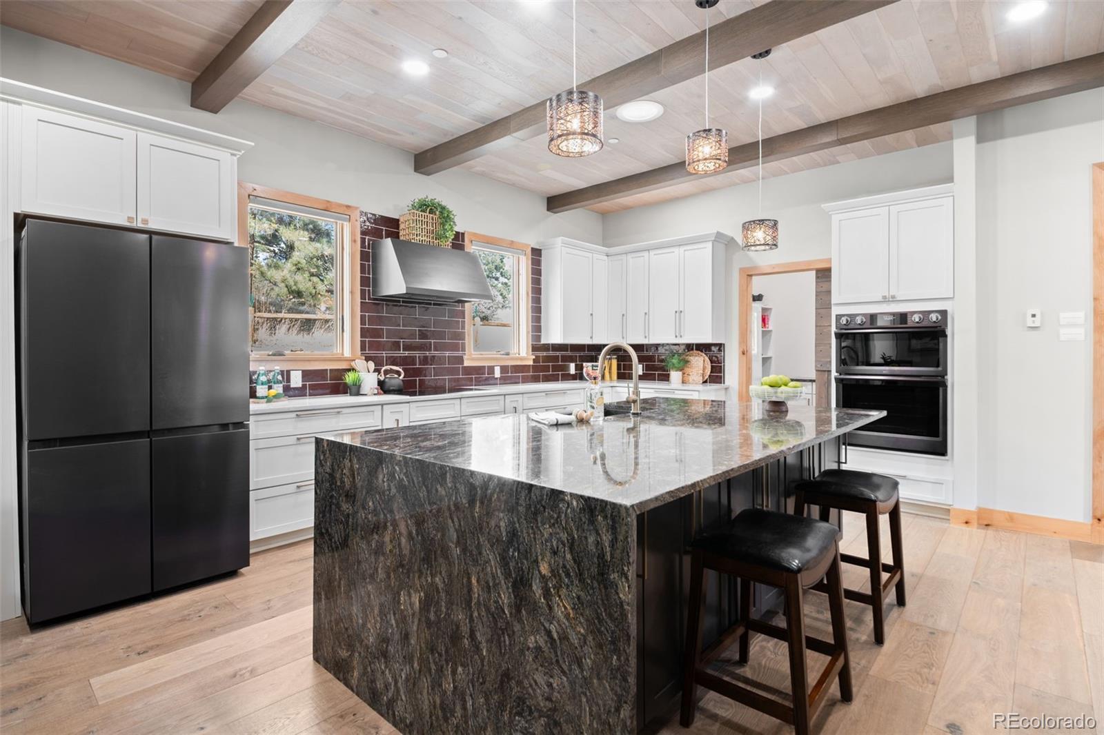 25350 Ridge Way Golden, CO 80401 - Photo 11 of 47 a kitchen with stainless steel appliances granite countertop a sink refrigerator and cabinets