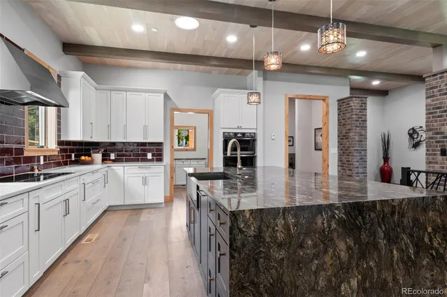 a view of kitchen with cabinets and a refrigerator