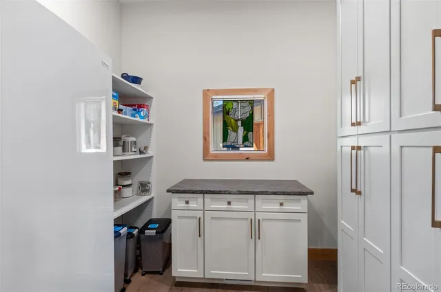 a kitchen with stainless steel appliances granite countertop a sink refrigerator and cabinets