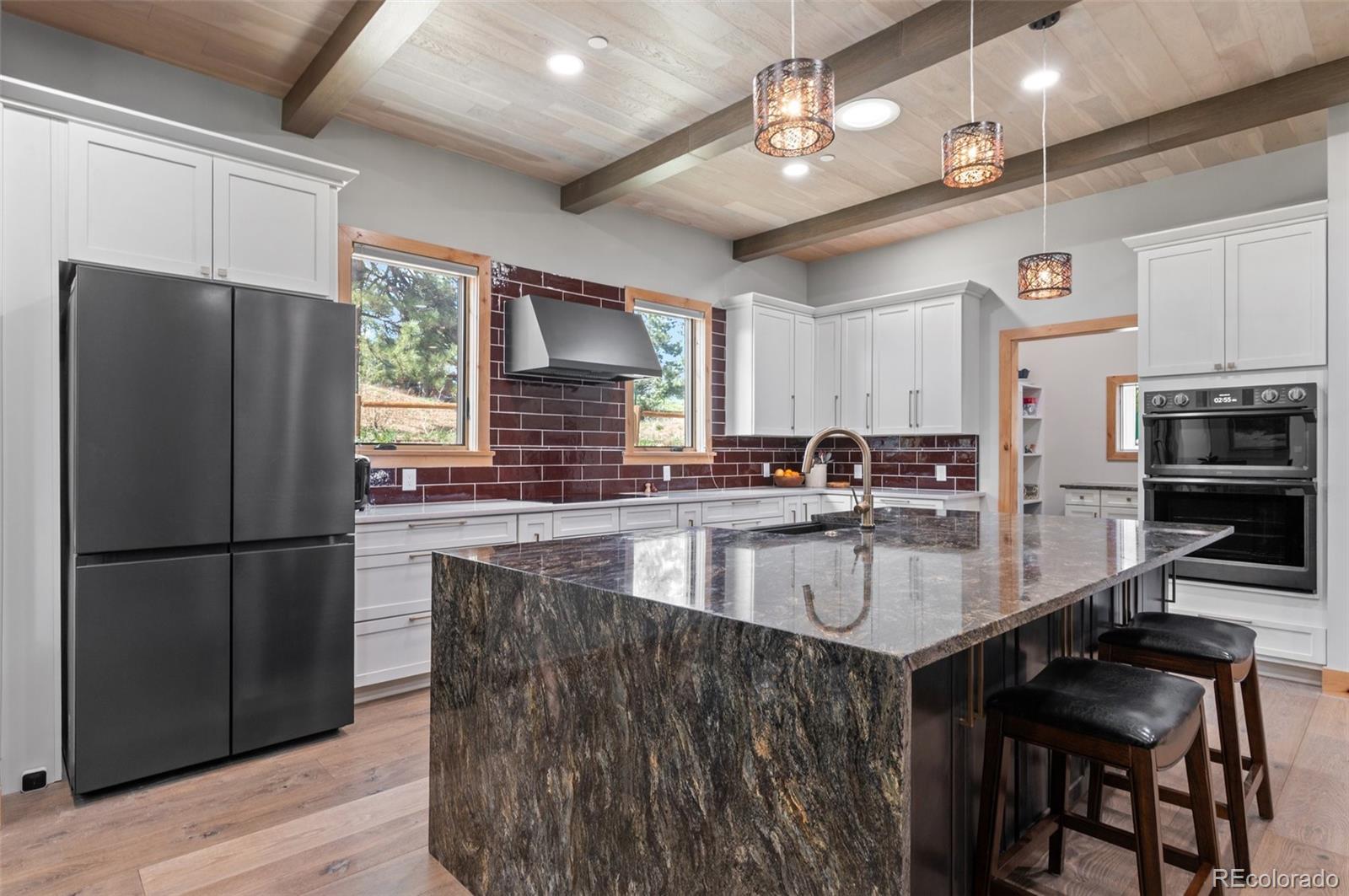 25350 Ridge Way Golden, CO 80401 - Photo 13 of 47 a kitchen with stainless steel appliances granite countertop a sink refrigerator and cabinets