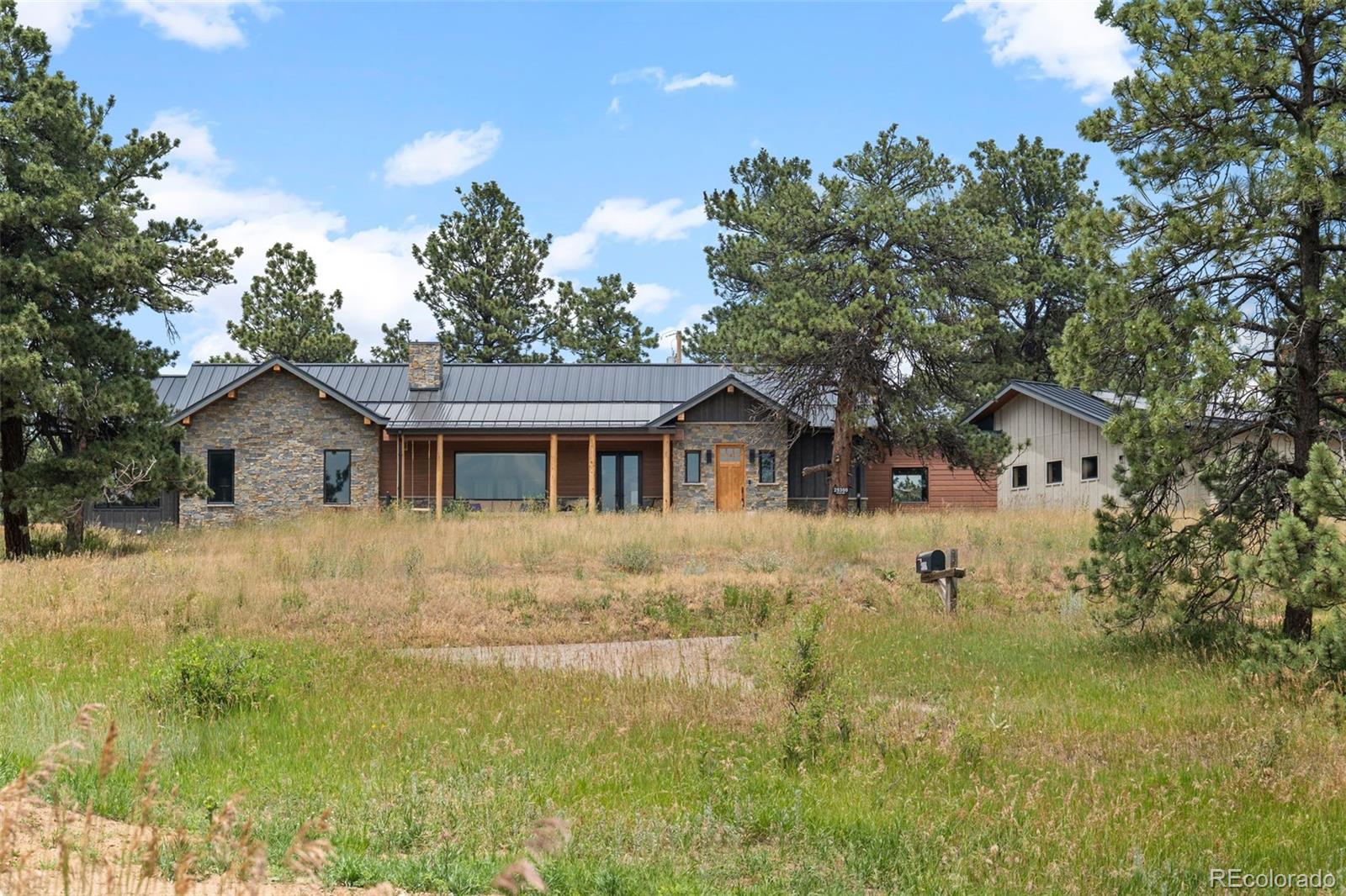 25350 Ridge Way Golden, CO 80401 - Photo 2 of 47 a front view of house with yard and trees