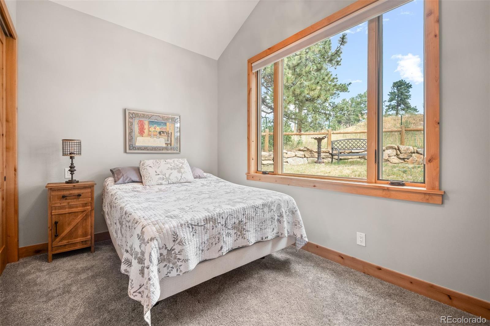 25350 Ridge Way Golden, CO 80401 - Photo 25 of 47 a bedroom with a bed and a large window