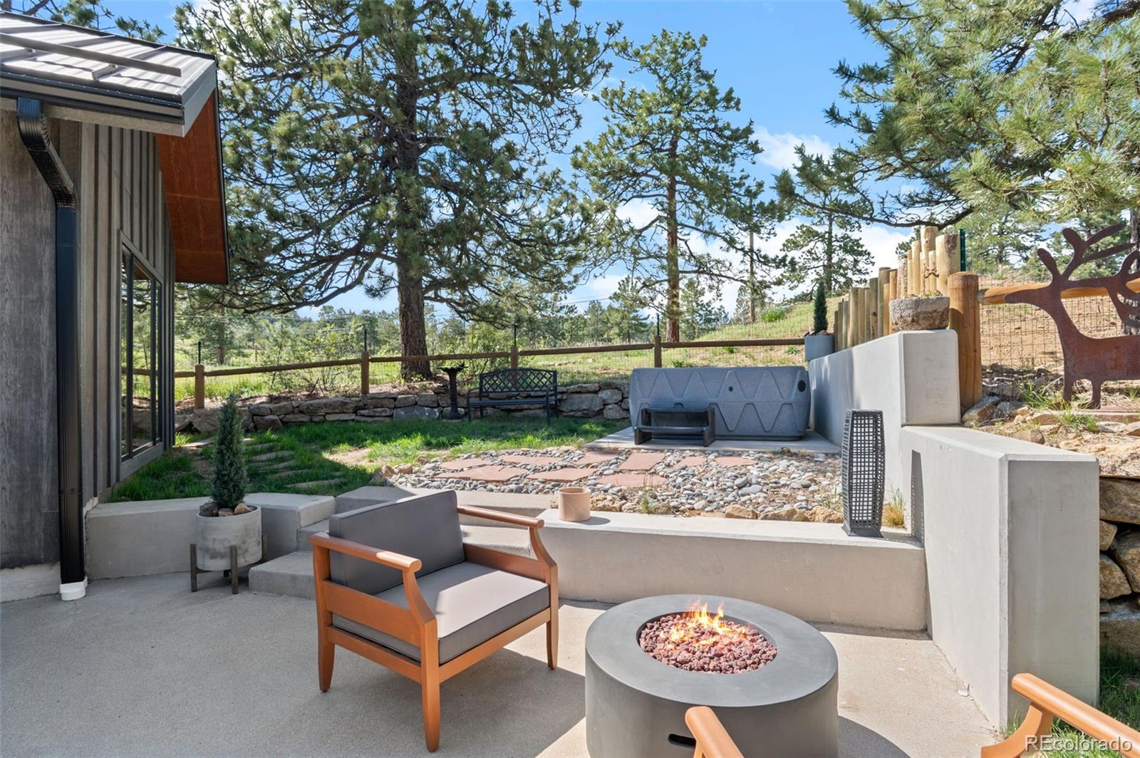 25350 Ridge Way Golden, CO 80401 - Photo 26 of 47 a view of backyard with outdoor seating and trees