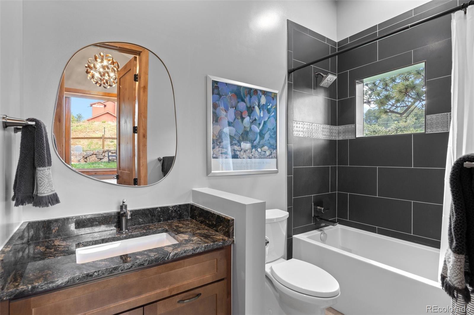 25350 Ridge Way Golden, CO 80401 - Photo 26 of 47 a bathroom with a sink a toilet and a bathtub