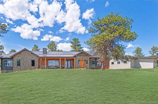 a front view of house with a garden
