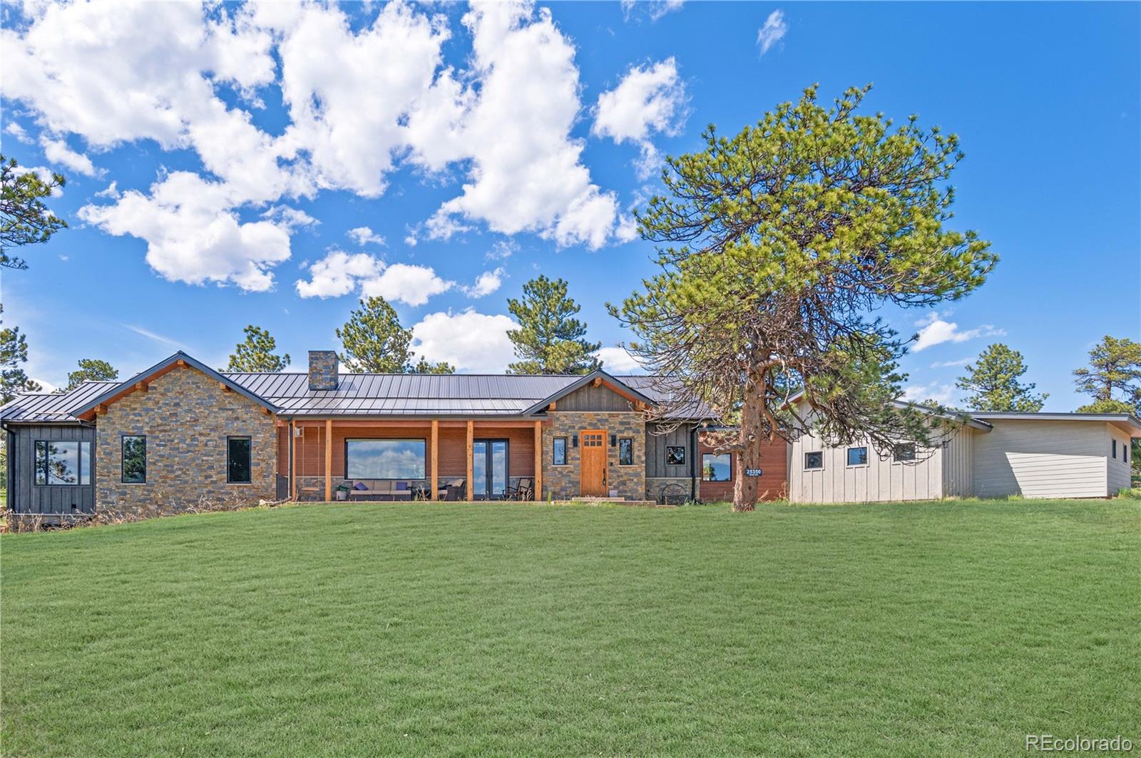 25350 Ridge Way Golden, CO 80401 - Photo 3 of 47 a front view of house with a garden
