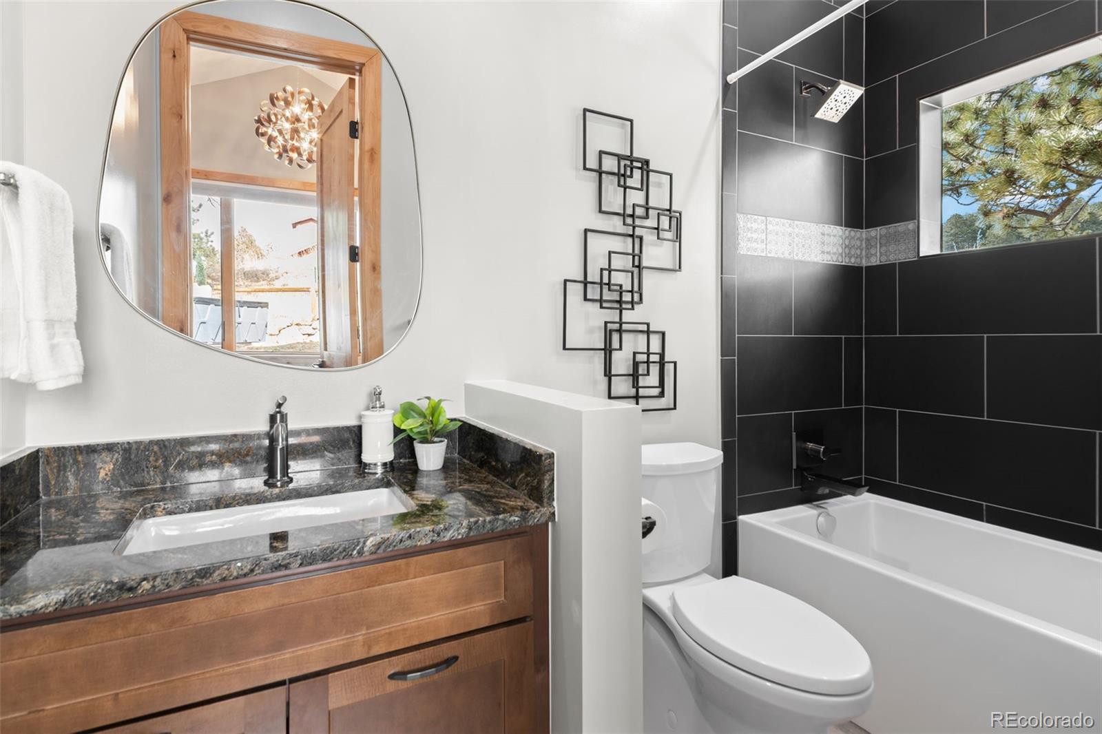 25350 Ridge Way Golden, CO 80401 - Photo 37 of 47 a bathroom with a granite countertop sink a toilet and a bathtub