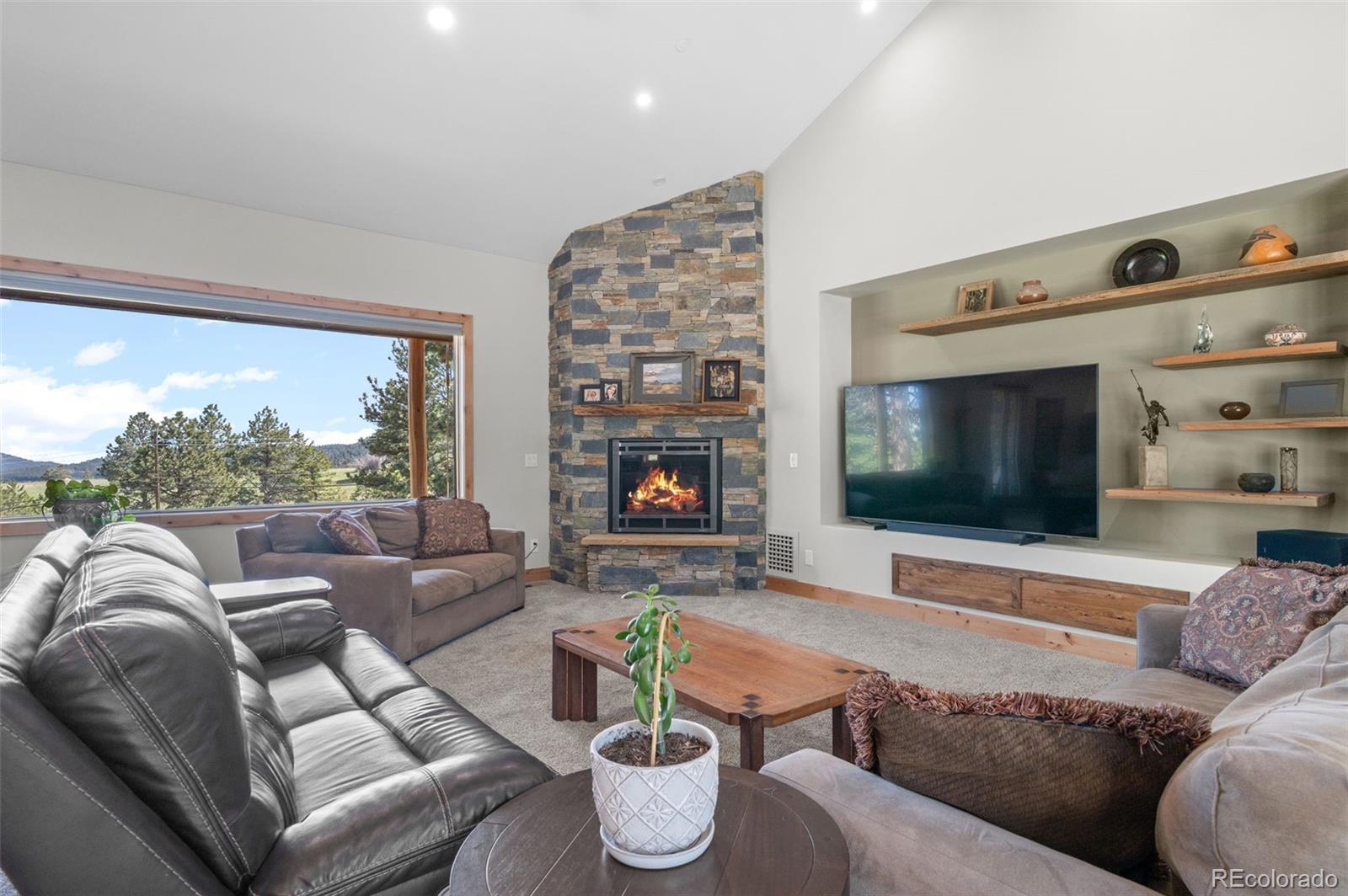 25350 Ridge Way Golden, CO 80401 - Photo 9 of 47 a living room with furniture and a flat screen tv