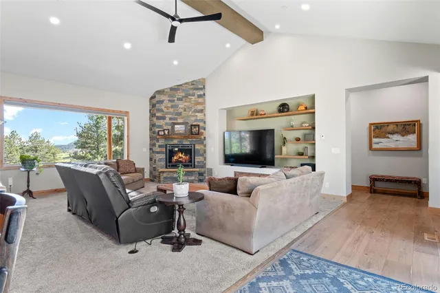 a living room with furniture a flat screen tv and a large window